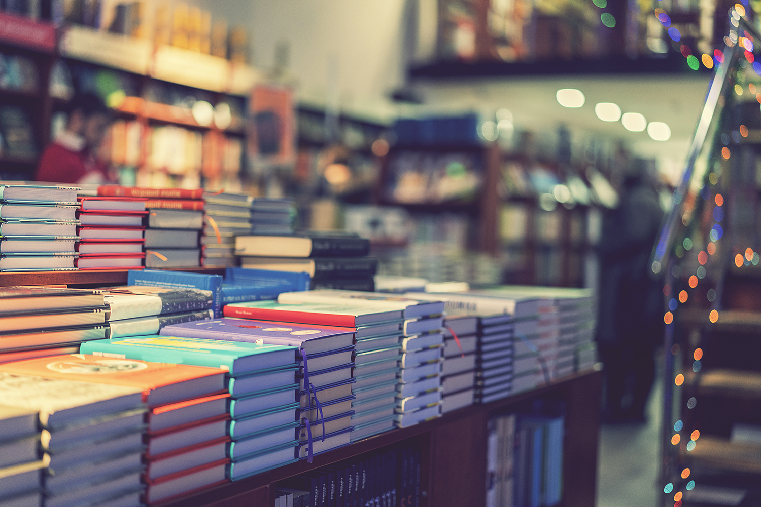 Books stacked on table representing Professional Book Studios' comprehensive service